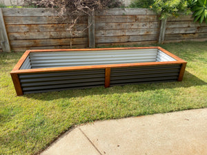 The image on our website is a photograph of our premium raised garden beds. The raised garden beds are made of high-quality materials and has a spacious design that can hold a large amount of vegetable, fruit of herbs. The raised garden beds are designed to keep your produce organized, and its stylish design will complement any outdoor space. The photograph shows the garden beds in a natural outdoor setting, surrounded by trees and greenery.