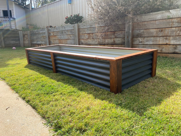  The image on our website is a photograph of our premium raised garden beds. The raised garden beds are made of high-quality materials and has a spacious design that can hold a large amount of vegetable, fruit of herbs. The raised garden beds are designed to keep your produce organized, and its stylish design will complement any outdoor space. The photograph shows the garden beds in a natural outdoor setting, surrounded by trees and greenery.